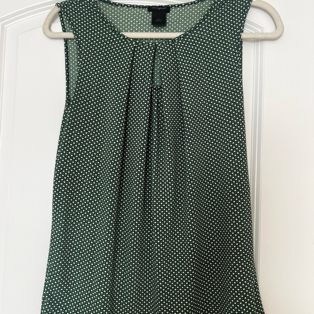 Soft, pretty green sleeveless blouse. Pairs great with a suit, jeans or a skirt.